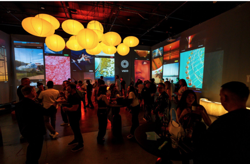 A photo of people at a VSCO event or party with low lighting and paper lanterns. 